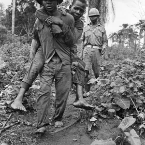 A Biafran soldier seen here carrying an injured comrade during the Biafra conflict A Biafran soldier seen here carrying an injured comrade during the Biafra conflict