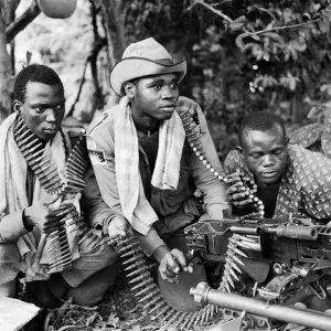Three Biafran soldiers seen here operating a heavy machine gun during the Biafran conlict Three Biafran soldiers seen here operating a heavy machine gun during the Biafran conlict
