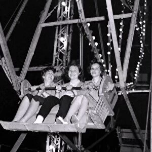 As the big Wheel turns, these three ladies can y help but smile