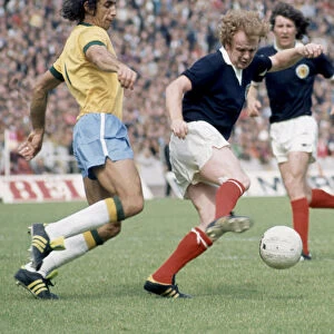 Billy Bremner in action against Wilson Piazza for Scotland in their World Cup match