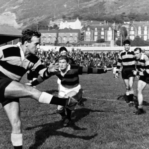 Billy Hullin, Cardiff Rugby Union Player, clears before John Davies of Aberavon can close Billy Hullin, Cardiff Rugby Union Player, clears before John Davies of Aberavon can close