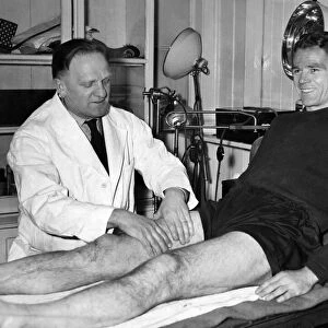 Billy Liddell, gets a massage from Albert Shelley, trainer, after his morning training
