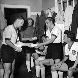 Billy Liddell (left) meets opposition team players in the changing room at Anfield before