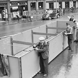 Birmingham council workmen construct an emergency water container in the city centre