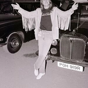 Black Sabbath singer Ozzy Osbourne poses next to a car after performing in concert August