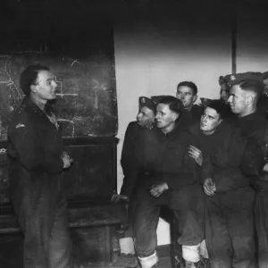 A blackboard lecture on parachutists by Lieutenant Ewart Evans to men of the Welch