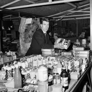 Blackburn Rovers footballer Bryan Douglas serving on his stall at the Morecambe market