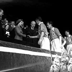 Blackpool footballer Stanley Matthews shakes hands with Her Majesty Queen Elizabeth II