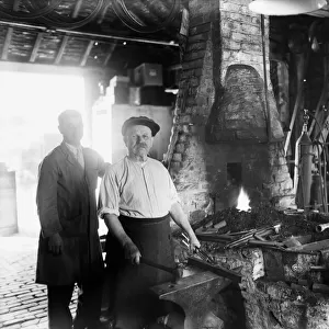 Blacksmith at work in the Old Forge, Iver. Circa 1936