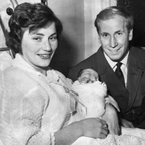 Bobby Charlton Print - A photograph of a proud father with his newborn baby Bobby Charlton Print - A photograph of a proud father with his newborn baby
