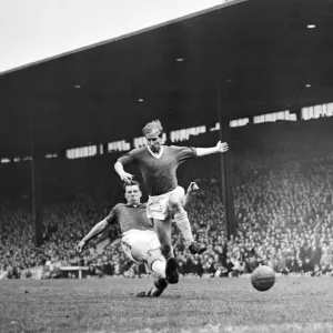 Bobby Charlton leaps to elude a defender during the match between Manchester United