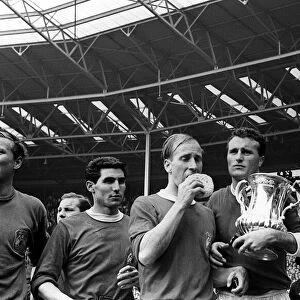 Bobby Charlton with sponge and Noel Cantwell holding the trophy after beating Leicester