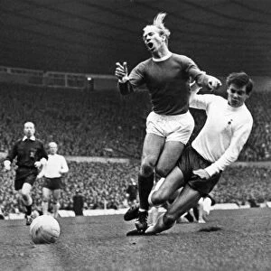 Bobby Charlton is tacked by Cyril Knowles during the Manchester United verses Tottenham