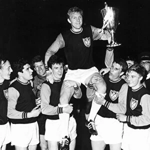 Bobby Moore captain of West Ham United 1965 with teammates after winning