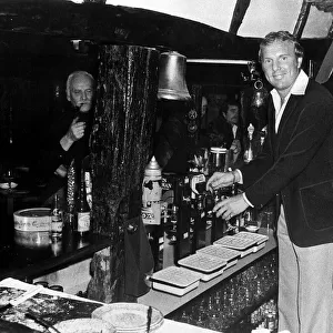 Bobby Moore ex footballer serving drink behind bar The Three Horseshoes