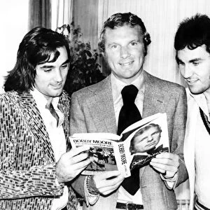 Bobby Moore with George Best and Gerry Francis at the launch of his book called "