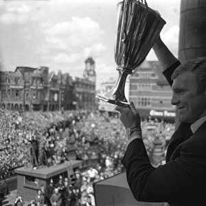 Bobby Moore holds aloft the European Cup Winners Cup trophy to the people of West Ham