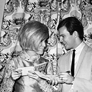 Bobby Vee and Dusty Springfield exchange autographs during the interval of their one