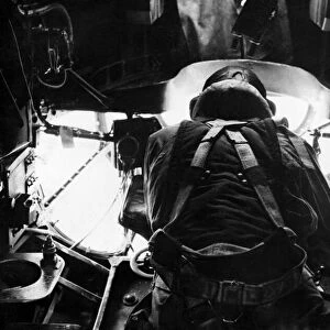 A bomb aimer in position in the nose of an RAF Stirling bomber during an assault