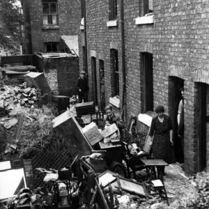 Bomb damage in Liverpool. Residents in these cottages salvaging their belongings after an Bomb damage in Liverpool. Residents in these cottages salvaging their belongings after an