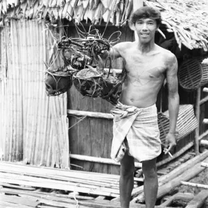 A Borneo Headhunter Tribesman with Human Skulls Print, 1975 A Borneo Headhunter Tribesman with Human Skulls Print, 1975