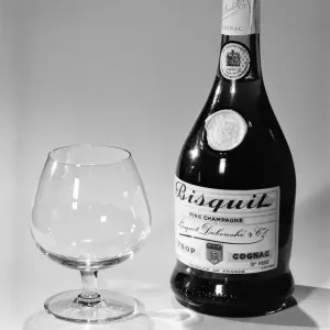 Bottles of wines and spirits with glasses. 1959 D69-006