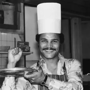 Boxer John Conteh with a chefs hat on. 28th September 1977