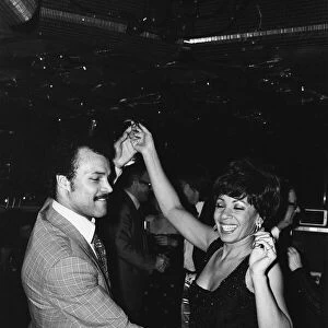 Boxer John Conteh dancing with Shirley Bassey at her party. 17th July 1979