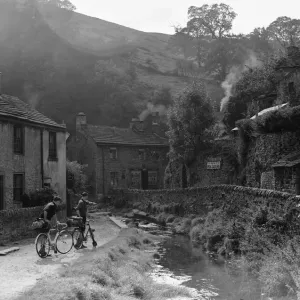 Two boys out on their bicycles near a stream in the Peak District village of Castletown Two boys out on their bicycles near a stream in the Peak District village of Castletown