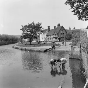Boys fishing for tadpoles in Eynsford, Kent. 25th May 1961 Boys fishing for tadpoles in Eynsford, Kent. 25th May 1961