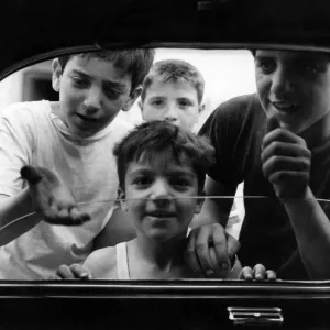 Boys from the slum areas of Naples in southern Italy beg for money through car windows Boys from the slum areas of Naples in southern Italy beg for money through car windows
