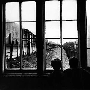 Two boys are watching out for trains at the derelict Heaton Railway Station on 4th