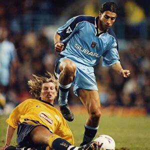 Breaking away: Youssef Chippo is challenged by Robbie Savage
