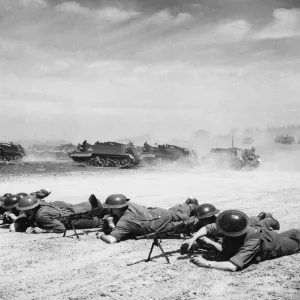 Bren carriers in action while the carriers pass in the background. 25th June 1941 Bren carriers in action while the carriers pass in the background. 25th June 1941