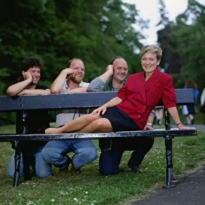Brenda Paterson TV presenter July 1989 sitting on a park bench with three men