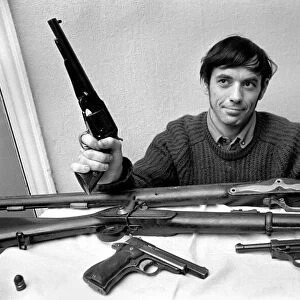 Brian Entwistle with his son, Nigel (5) and his collection of guns - a hand-reproduction