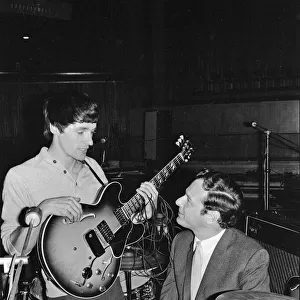 Brian Epstein (right) talks to a guitarist from one of the British bands appearing
