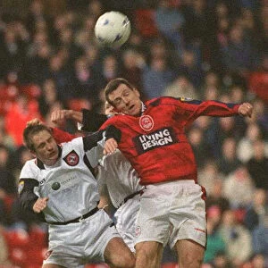 Brian Irvine Aberdeen football player challenges Dundee United players for the ball at