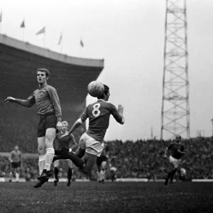 Brian Kidd of Manchester United in an aerial challenge for the ball with an Ipswich Town