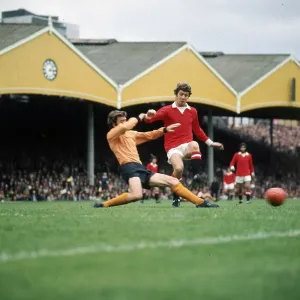 Brian Kidd of Manchester United takes on v J McAlle of Wolves Brian Kidd of Manchester United takes on v J McAlle of Wolves