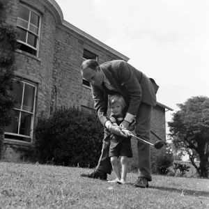 Brigadier Fitzroy Maclean playing with his son Charles in their garden at home in Yealand Brigadier Fitzroy Maclean playing with his son Charles in their garden at home in Yealand