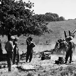 A British 5. 5 gun shelling the enemy over wooded slopes near Vallee, on the road Falaise