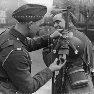 British Army, a fellow soldier adjust the lady doll to his comrades gun British Army, a fellow soldier adjust the lady doll to his comrades gun