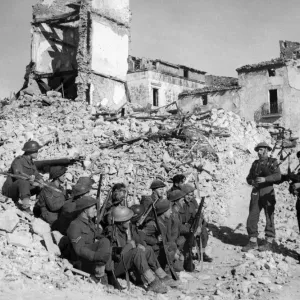 British army pipers of the 5th Army entertain their comrades in a heavily damaged village British army pipers of the 5th Army entertain their comrades in a heavily damaged village