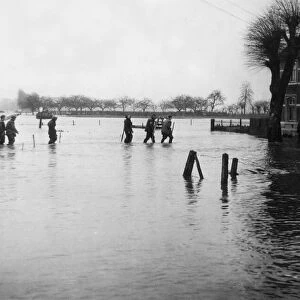 British Army sappers of the Royal Engineers wade through the floods on the banks of