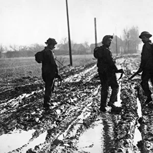 British army soldiers making their way up to the front line in Holland through deep mud