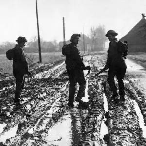 British army soldiers making their way up to the front line in Holland through deep mud