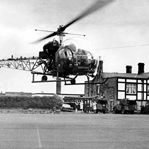 A British Army Westland Sioux helicopter dropped into the car park at the Jingling Gate