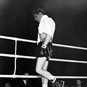 British boxer Walter Cartier looking dejected as he walks from the ring after creating a