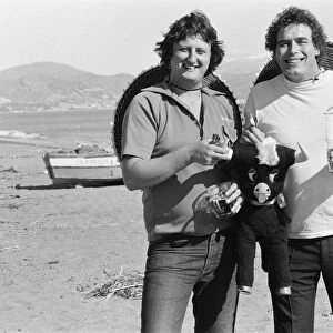 British darts player Eric Bristow poses on the beach with Bobby George at Torremolinos